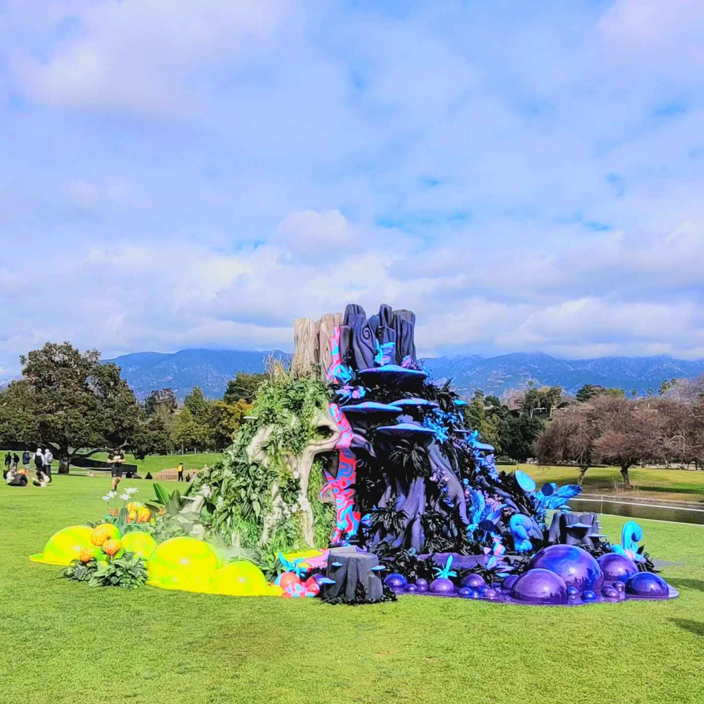 Image of a structure that is half green with grass and half purple with poisonous trails.